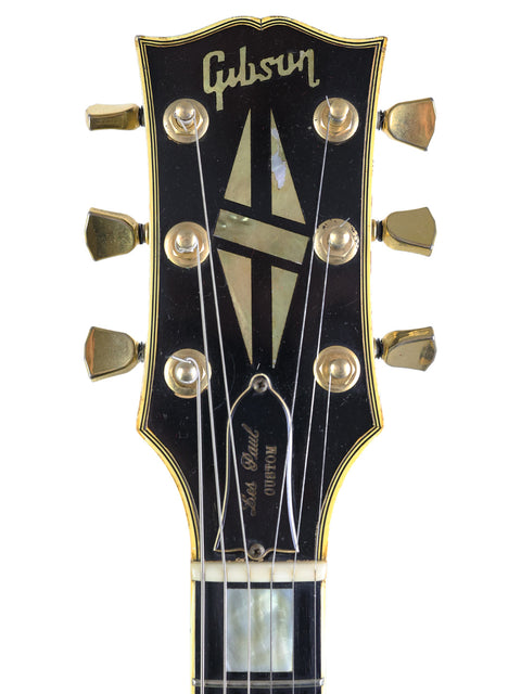 1969 Gibson Les Paul Custom, a vintage electric guitar known for its iconic style and rich sound.
