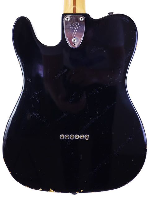 1978 Fender Telecaster Custom in black with a luxurious gold pickguard, showcasing classic design and craftsmanship.
