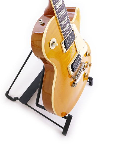 1991 Gibson Les Paul Classic 1960 Reissue guitar displayed on a stand with a plain white backdrop.
