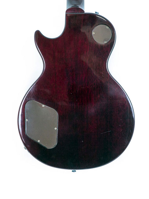 1991 Gibson Les Paul Standard guitar featuring a dark red body and sleek black pickguard, perfect for any music lover.