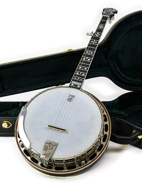  2008 Deering Golden Era Banjo is displayed in its case on a white surface, highlighting its craftsmanship and beauty.