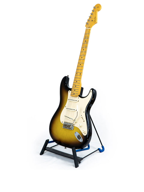 2008 Fender Custom Shop Time Machine 58 Strat Relic guitar on a stand, featuring a simple white background for emphasis.
