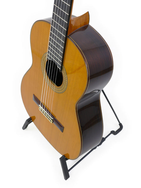 2021 Francisco Esteve 9C/B classical guitar resting on a stand, highlighted by a stark white background.