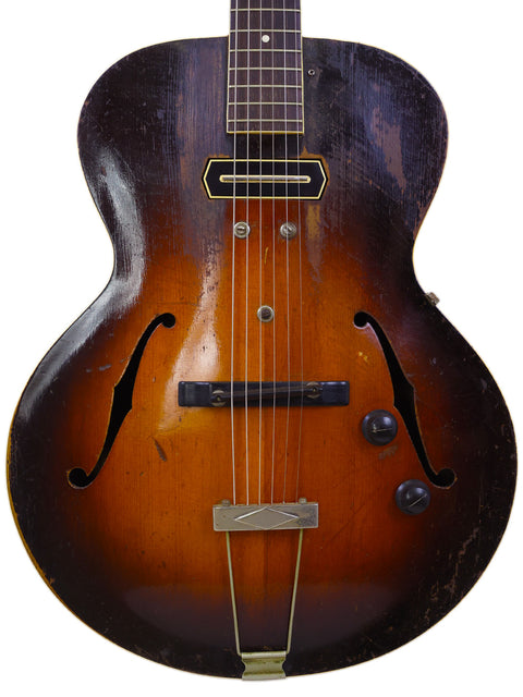 A 1953 Gibson J-45 sunburst electric guitar, featuring a beautiful finish and iconic shape, perfect for music enthusiasts.