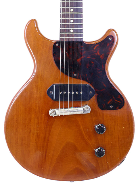 A 1959 Gibson Les Paul Jr guitar featuring a wooden body and black pickguard, highlighting its vintage appeal.