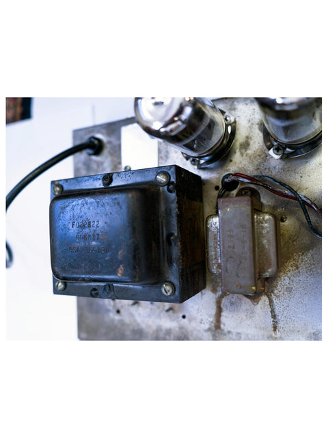 A 1961 Fender 6G12A Concert Amp, showcasing its old electronic components, wires, and power supply.
