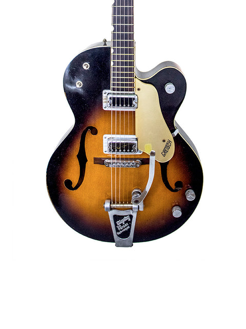 A 1964 Gretsch Double Anniversary 6117 guitar showcasing a sunburst finish and a contrasting black pickguard.