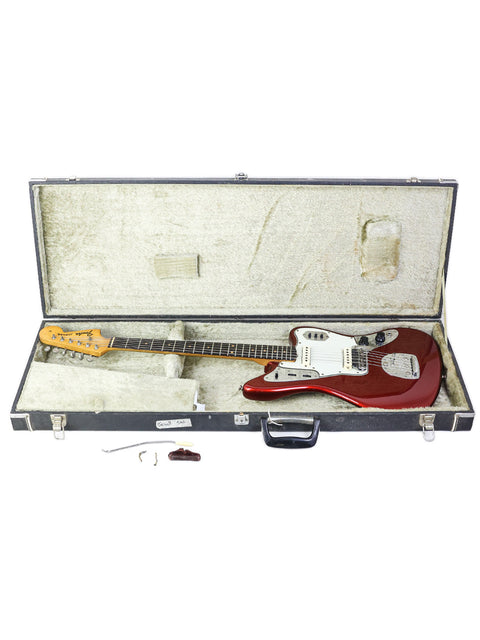A 1964 USA Fender Jaguar electric guitar in its case, featuring a guitar pick, representing vintage style and quality.
