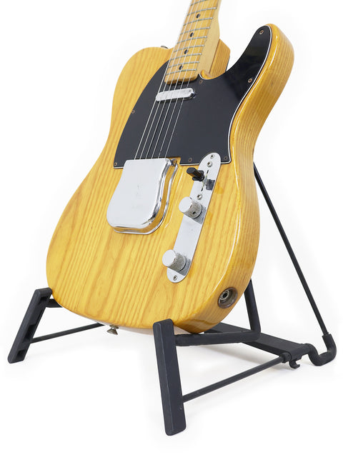 A 1977-78 Vintage Fender Telecaster resting on a black stand, highlighting its iconic shape and craftsmanship.