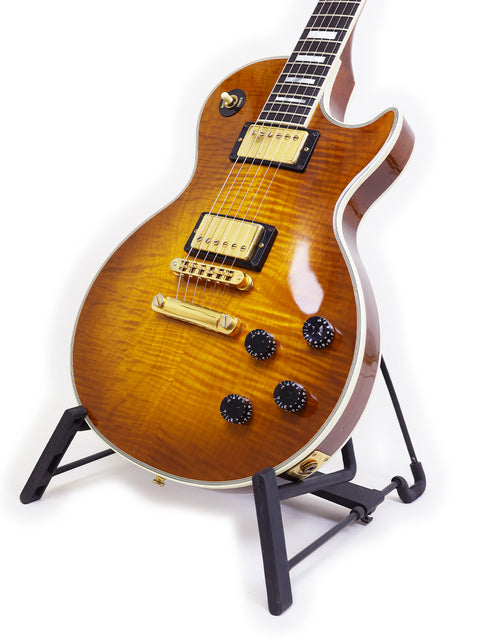A 1994 Gibson Les Paul Custom guitar elegantly positioned on a stand with a bright white backdrop.