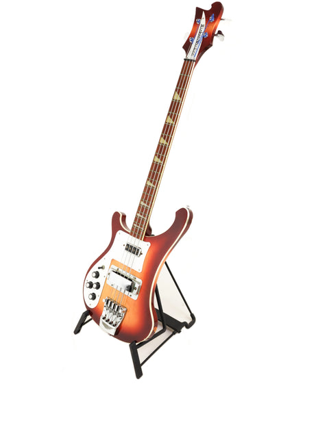 A 1997 Rickenbacker 4003 Fireglo Bass guitar resting on a stand, set against a white background.