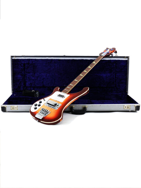 A 1997 Rickenbacker 4003 Fireglo bass guitar in a protective case, isolated on a white backdrop.