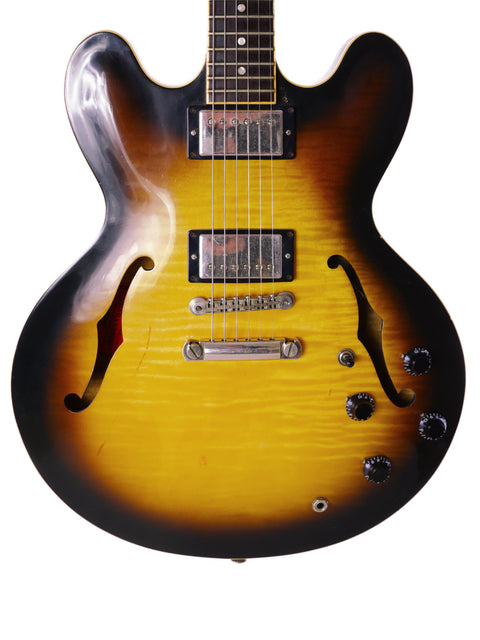 A 2006 Gibson ES-335 guitar featuring a vibrant sunburst finish, highlighting its classic style and rich tones.