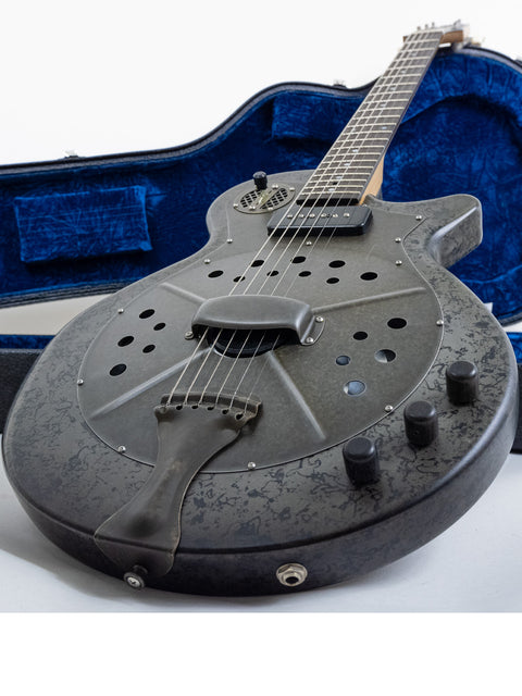 A 2009 National Reso-Phonic Polychrome Tricone Resonator guitar with its case on a clean white background.
