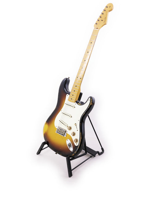 A 2015 Fender Jason Smith Masterbuilt Stratocaster '57 Reissue displayed on a stand with a white backdrop.