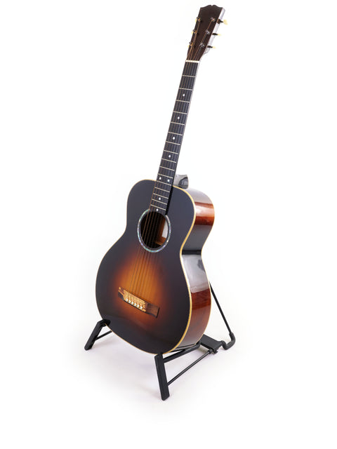 A Beau Hannam Parlour guitar from Australia, 2009, elegantly displayed on a stand against a clean white background.
