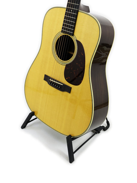 A Collings D2H acoustic guitar from 2006, showcasing its elegant design and rich wood finish, perfect for musicians.