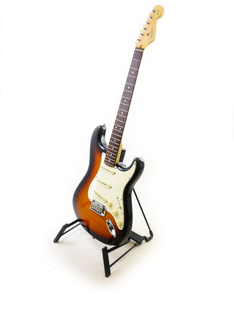 A Fender 60th Anniversary American Stratocaster guitar on a stand against a clean white background.
