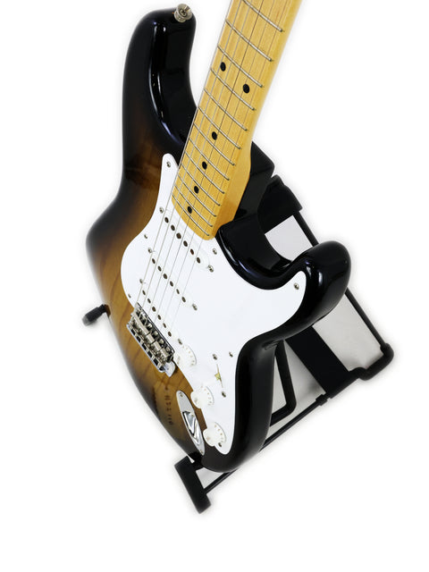 A Fender Custom Shop 50th Anniversary ‘54 Stratocaster guitar on a stand against a clean white background.