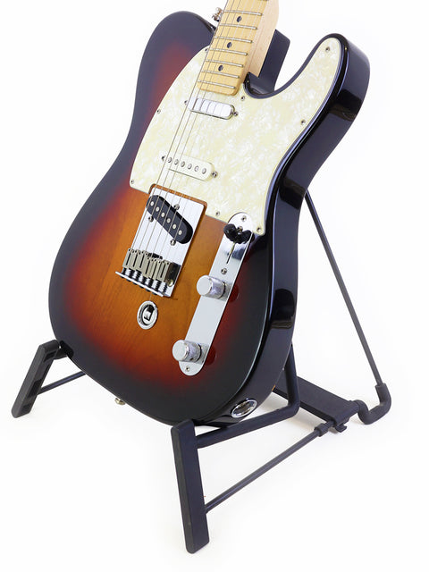 A Fender Nashville B-Bender Telecaster guitar displayed on a stand against a sleek black background.