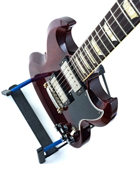 A Gibson Custom ’61 Les Paul SG Standard guitar positioned on a stand, emphasizing its iconic style and quality.