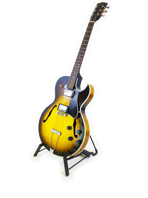 A Gibson ES-135 guitar, USA-made in 2001, positioned on a stand, emphasizing its vintage appeal and artistry.