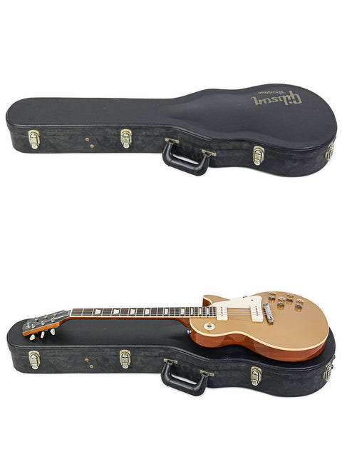 A Gibson Les Paul LPR-4 1954 Reissue and another guitar, both in cases, next to a guitar case on a flat surface.