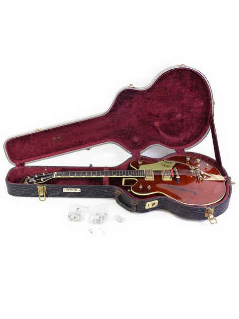 A Gibson Les Paul electric guitar displayed with a 1967 Gretsch 6122 Chet Atkins Country Gentleman, highlighting vintage craftsmanship.
