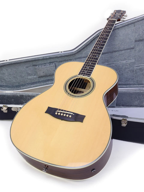 A Maton Custom Shop Classic guitar resting in a case against a white backdrop, highlighting its craftsmanship from Australia 2020.
