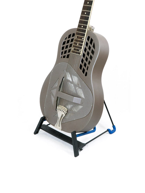 A National Reso-Phonic Polychrome Tricone Resonator guitar resting on a stand, set against a striking blue background.