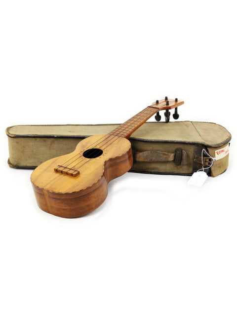 A Royal Style 3 Koa Ukulele, c.1916, resting in its case on a white background, emphasizing its classic Hawaiian design.