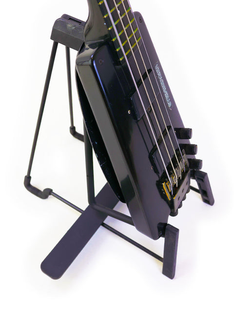 A Steinberger L2 Bass guitar from 1982 elegantly positioned on a stand, ready for a jam session or display.
