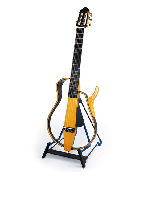 A Yamaha SLG 120NW Silent Guitar with a striking yellow neck, positioned on a stand, highlighting its Japanese craftsmanship, 2009.