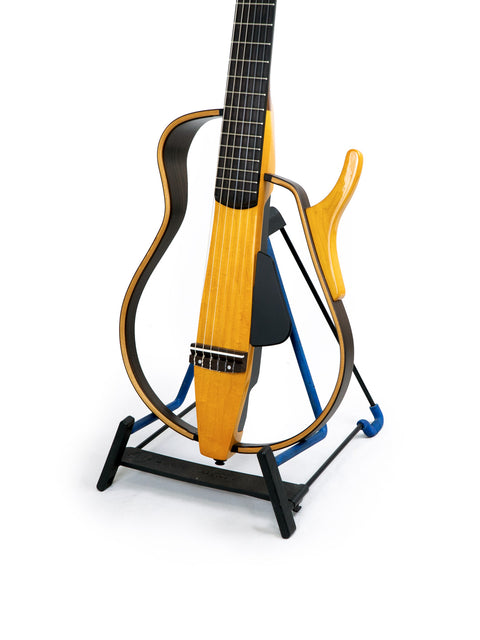 A Yamaha SLG 120NW Silent Guitar with a yellow neck resting on a stand, showcasing its sleek design from Japan, 2009.