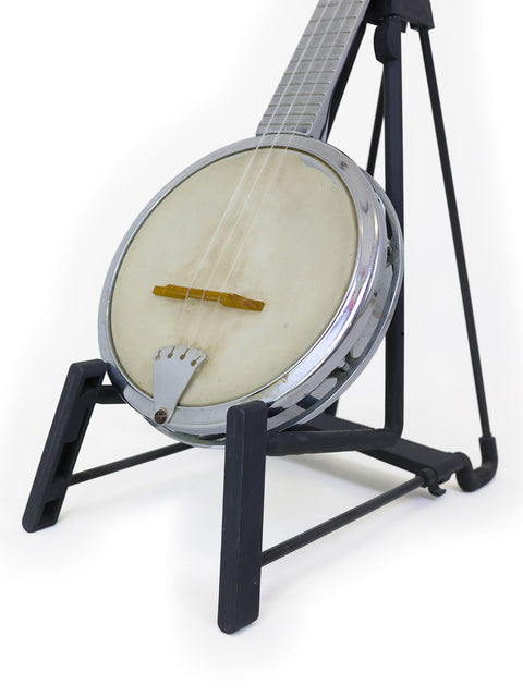 A banjo on a black stand against a white background.