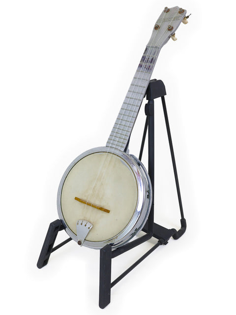 A banjo on a black stand against a white background.