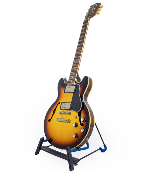 A beautiful Gibson Custom Shop ES 339 Memphis guitar from 2009 is positioned on a guitar stand, ready to play.