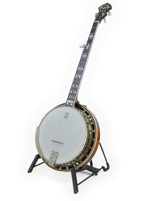 A beautifully crafted Deering Golden Era Banjo from 2008, prominently featured on a stand, highlighting its exquisite details.