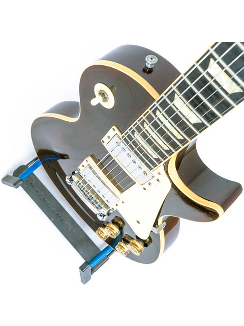 A black and gold 1991 Gibson Les Paul Standard guitar, showcasing a classic black pick guard.
