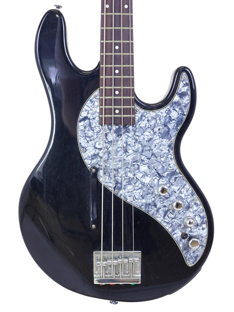 A black bass guitar featuring a vibrant floral pattern, model Line 6 Variax Bass from Korea, year 2004.
