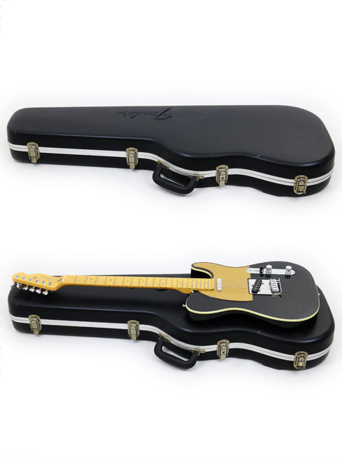 A black case holds two guitars, featuring a Fender American Deluxe Telecaster from 2005.
