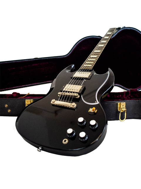 A black electric guitar nestled in a case, featuring the Gibson Custom Shop Wildwood Spec 1961 SG Standard Reissue, USA 2015.