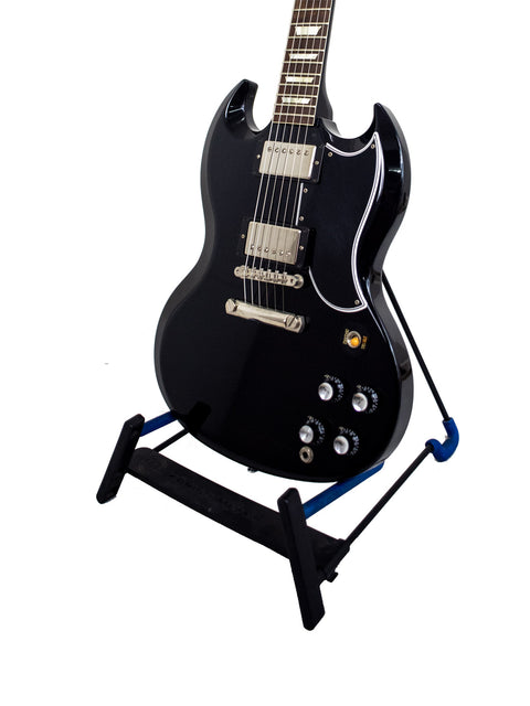 A black electric guitar resting on a stand, representing the Gibson Custom Shop Wildwood Spec 1961 SG Standard Reissue, USA 2015.
