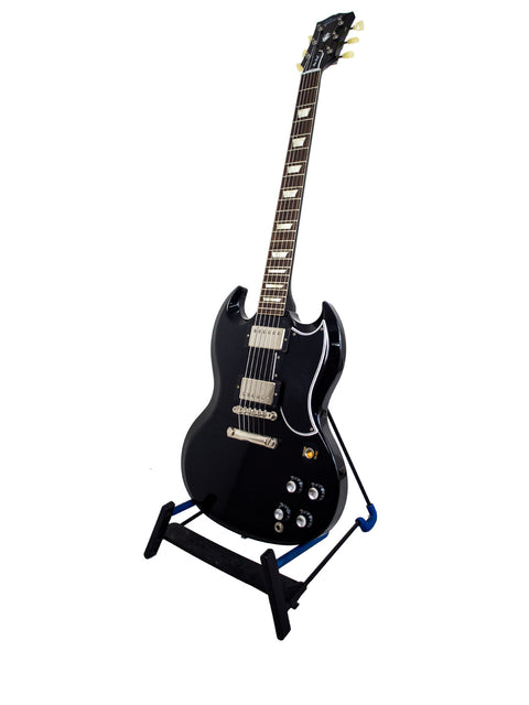 A black electric guitar rests on a stand, highlighting the Gibson Custom Shop Wildwood Spec 1961 SG Standard Reissue from 2015.