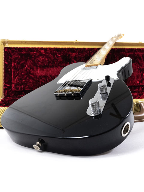 A black electric guitar securely housed in a case, featuring the Fender Custom Shop 30th Anniversary ’51 Nocaster NOS, 2017 model.