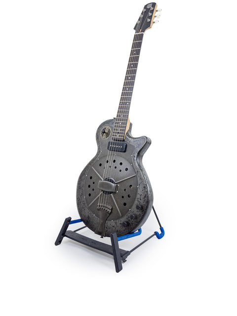 A blue-based stand holds a National Reso-Phonic Polychrome Tricone Resonator guitar, highlighting its craftsmanship from 2009.