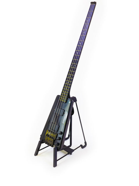 A blue-lit Steinberger L2 Bass guitar from 1982 displayed on a stand, showcasing its sleek design.