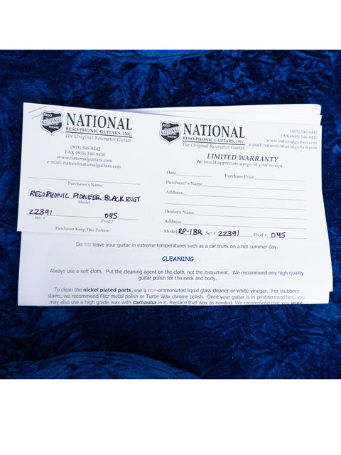 A blue blanket with a national certificate for the 2009 National Reso-Phonic Polychrome Tricone Resonator, USA.