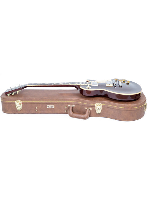 A brown guitar case is placed on top of a Gibson Les Paul Standard case, highlighting its vintage 1991 style.