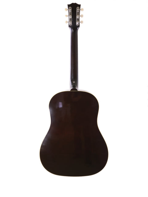 A brown guitar, the Gibson J-45 True Vintage from 2012, set against a stark white background, emphasizing its timeless beauty.